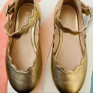 Golden leather scalloped girl’s ballerina shoes